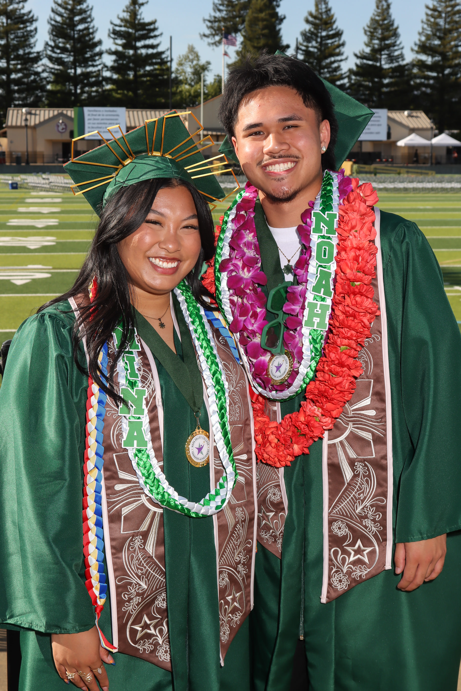 two grads smiling