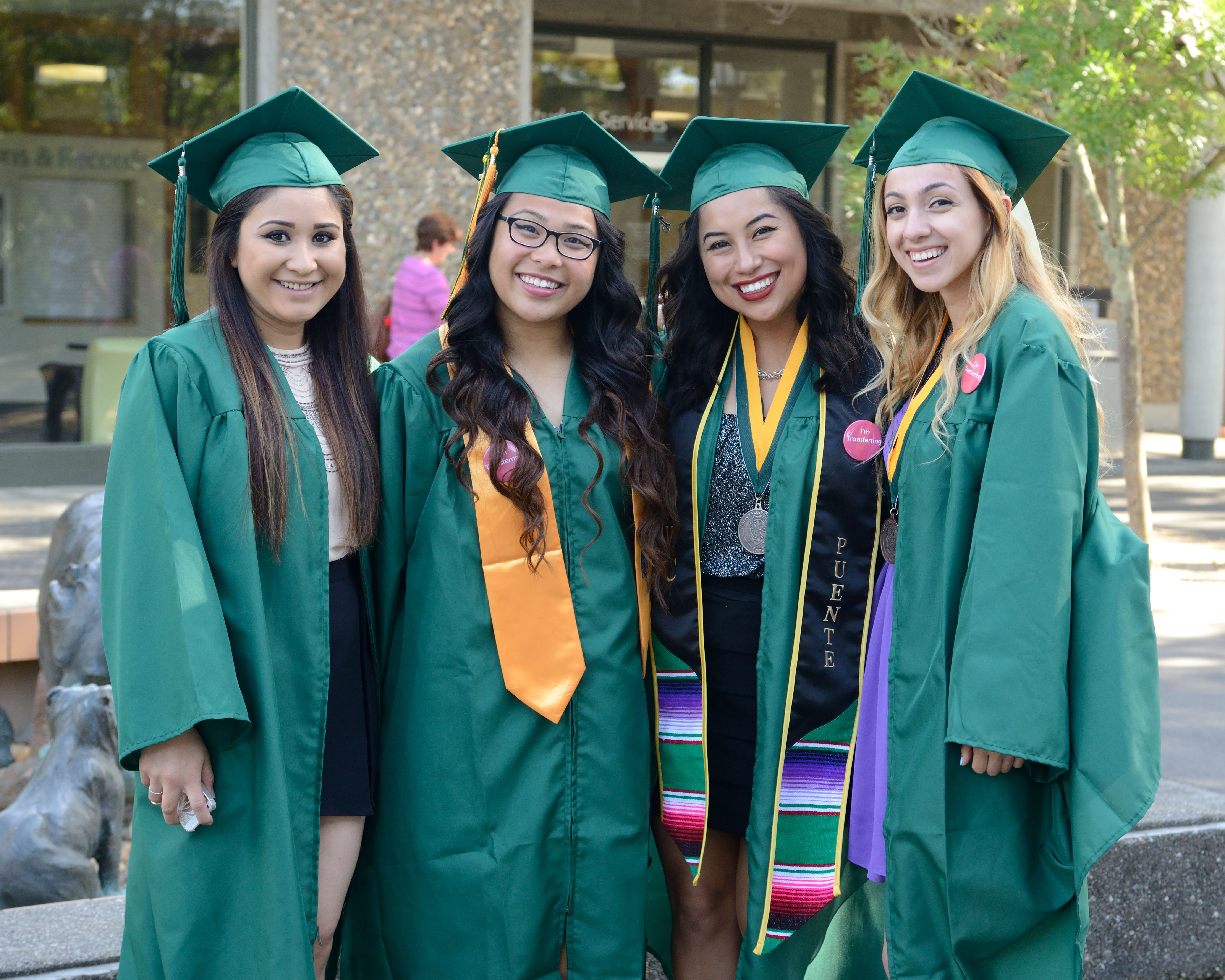 young women grads smiling